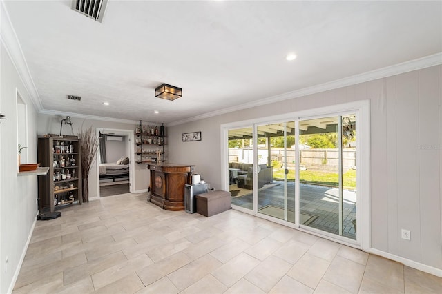 interior space with visible vents, crown molding, and a dry bar