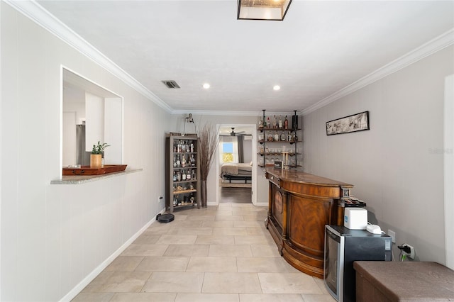 bar with a dry bar, light tile patterned floors, baseboards, visible vents, and ornamental molding