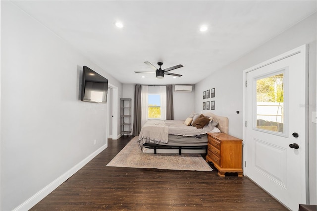 bedroom with dark wood-type flooring, multiple windows, baseboards, and a wall mounted AC