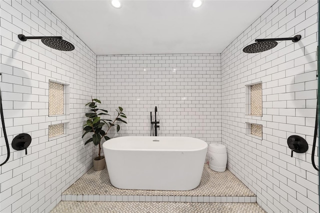 bathroom featuring tiled shower, a freestanding tub, tile patterned flooring, and tile walls