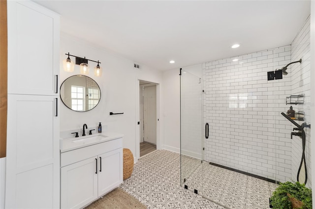 bathroom with visible vents, a shower stall, vanity, and recessed lighting