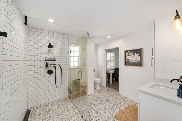 full bath featuring a stall shower, recessed lighting, toilet, and baseboards