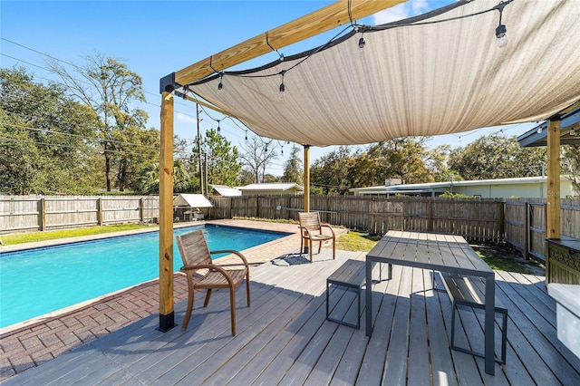 wooden deck featuring a fenced backyard and a fenced in pool