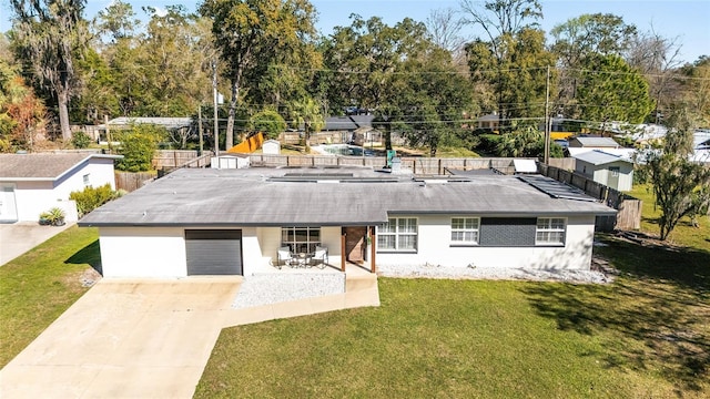 view of front of home with an attached garage, driveway, and a front lawn