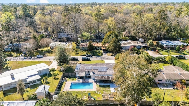 drone / aerial view featuring a forest view and a residential view