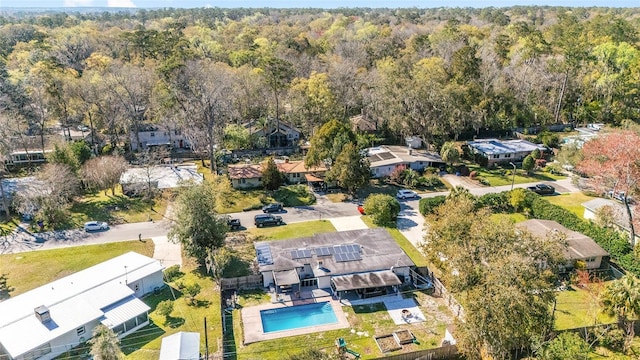 birds eye view of property featuring a residential view and a view of trees