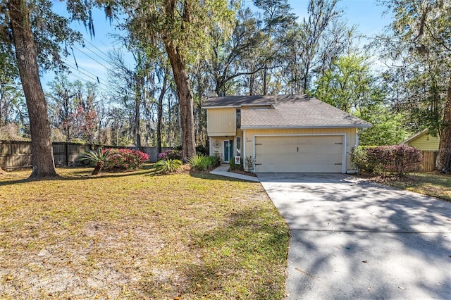 view of front facade with driveway, roof with shingles, an attached garage, fence, and a front yard