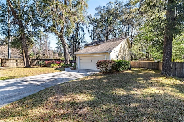 view of property exterior featuring a garage, a lawn, and fence