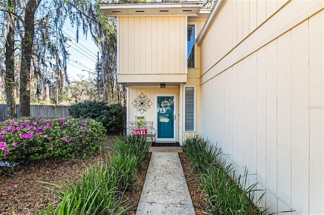 entrance to property featuring fence