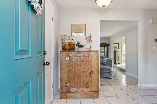 entrance foyer with light tile patterned flooring and baseboards