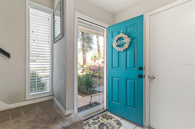 entryway featuring light tile patterned floors and baseboards