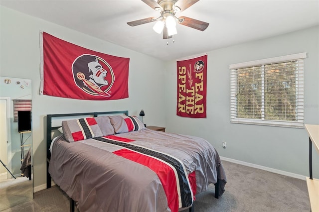 carpeted bedroom with ceiling fan and baseboards