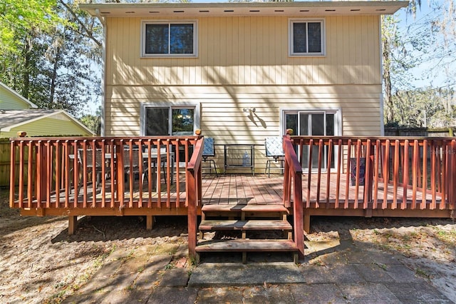 rear view of house featuring a wooden deck