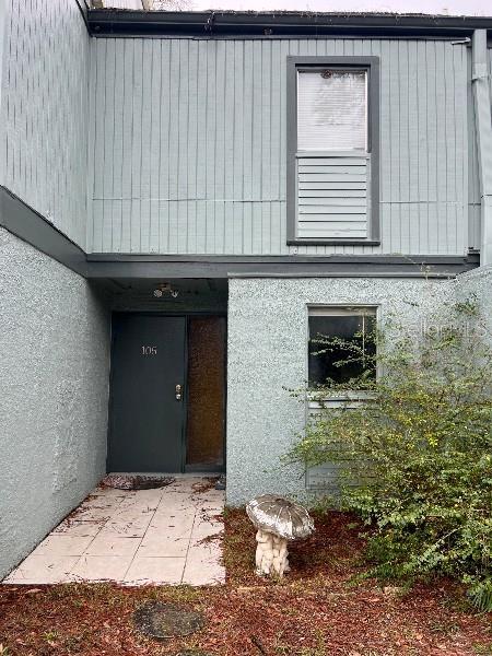 doorway to property with stucco siding