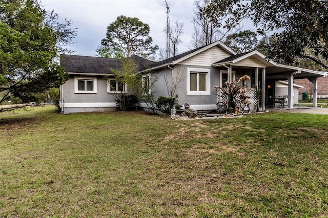 single story home featuring driveway, a front lawn, an attached carport, and stucco siding