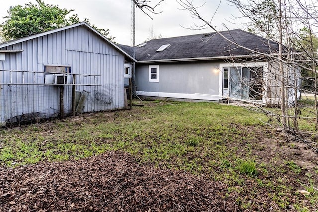 rear view of property with a yard