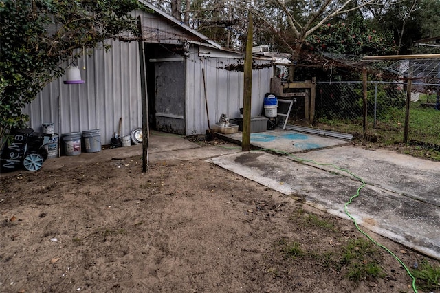 view of outbuilding featuring fence