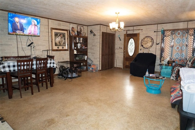 interior space featuring a chandelier and brick wall