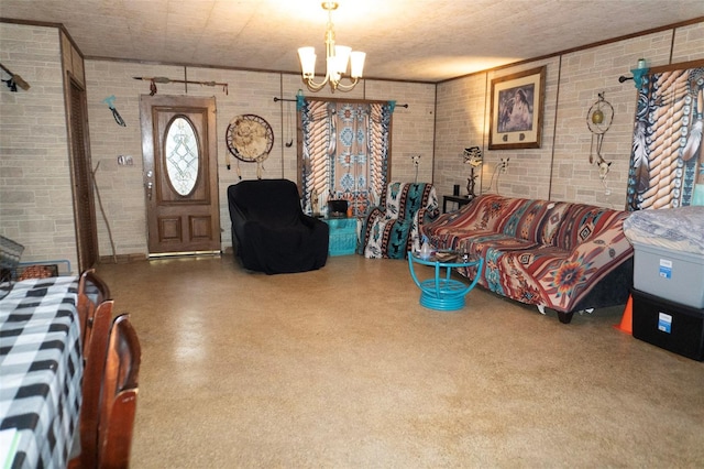 living room featuring brick wall and a notable chandelier