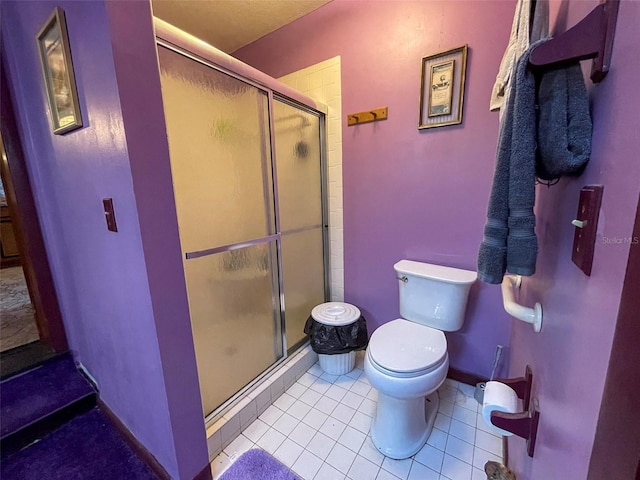 bathroom with a stall shower, tile patterned flooring, toilet, and baseboards