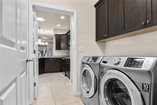 washroom with light tile patterned floors, recessed lighting, independent washer and dryer, cabinet space, and an inviting chandelier