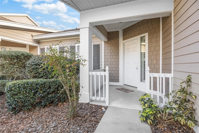 doorway to property featuring covered porch