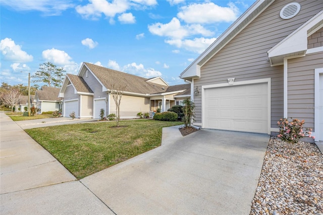 view of front of property featuring driveway, an attached garage, and a front yard