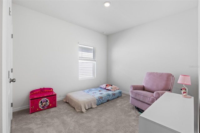 carpeted bedroom featuring baseboards