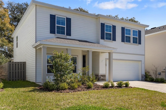 view of front of property featuring a garage, fence, stone siding, decorative driveway, and a front yard