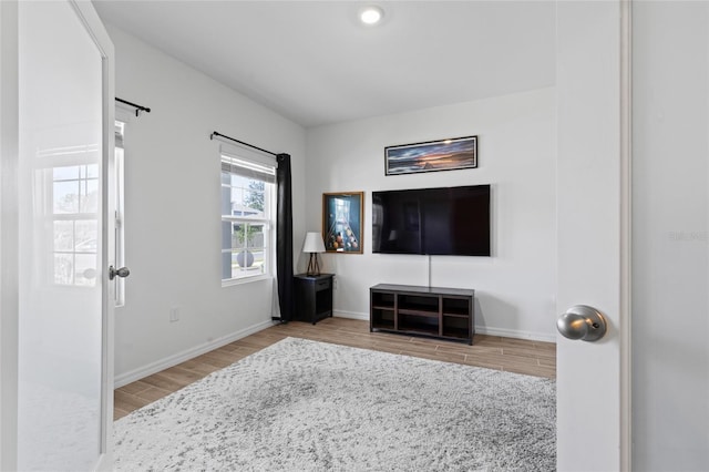 living area featuring baseboards and wood finished floors