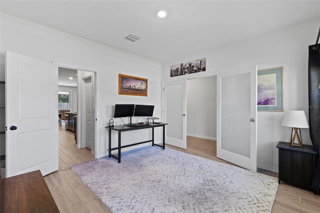 office space with light wood-style flooring, visible vents, baseboards, and recessed lighting