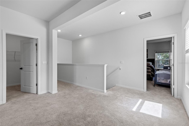 spare room featuring baseboards, carpet floors, visible vents, and recessed lighting