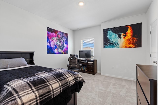 bedroom with baseboards and light colored carpet