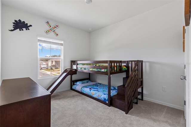 bedroom with carpet flooring and baseboards