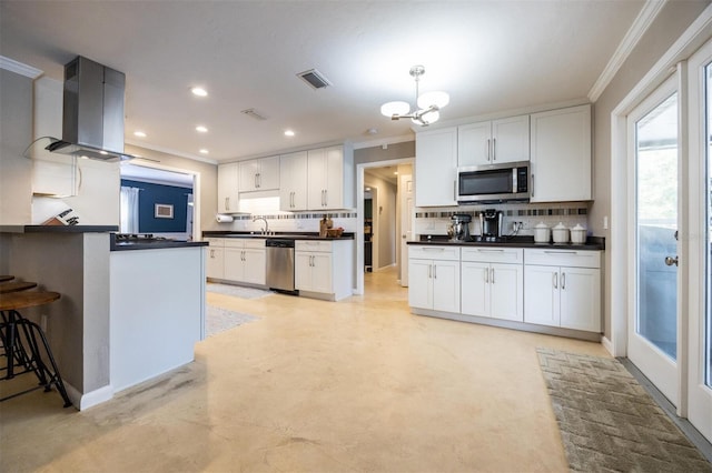 kitchen featuring island exhaust hood, crown molding, stainless steel appliances, and visible vents