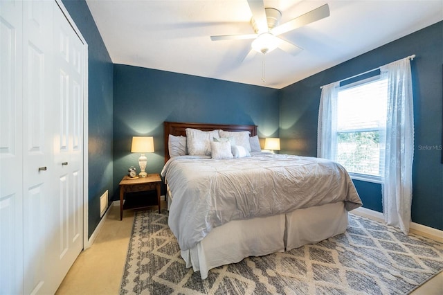 bedroom featuring a ceiling fan, baseboards, and a closet