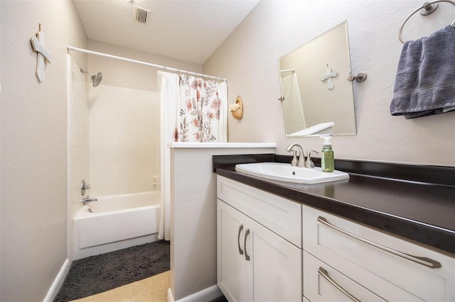 full bathroom featuring shower / tub combo, baseboards, vanity, and visible vents