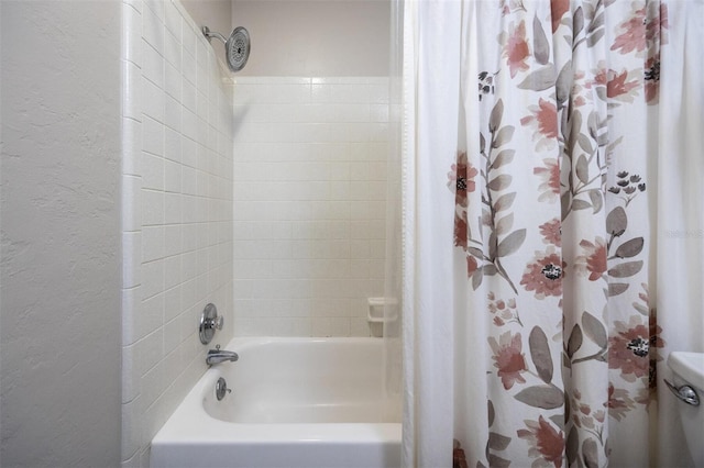 full bath featuring shower / tub combo with curtain, toilet, and a textured wall