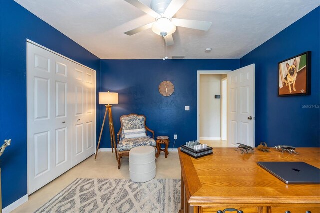 office area with baseboards, a ceiling fan, and visible vents