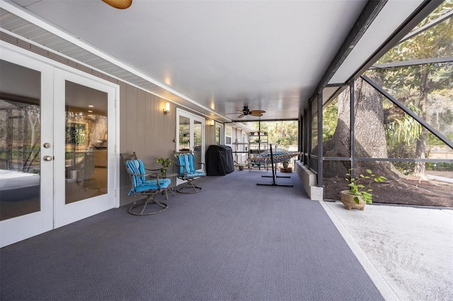 sunroom / solarium with a ceiling fan and french doors