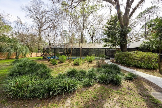 view of yard with fence and a fenced in pool
