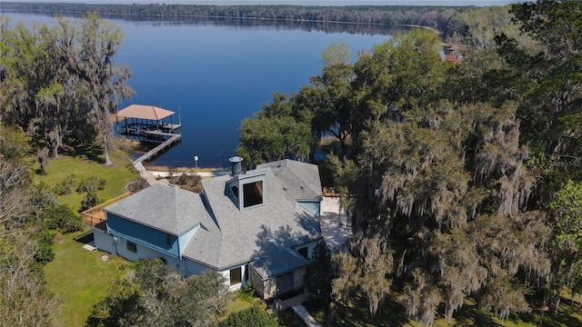 aerial view with a water view and a wooded view