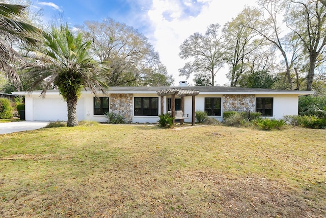 view of front facade with a front yard, stucco siding, a garage, stone siding, and driveway