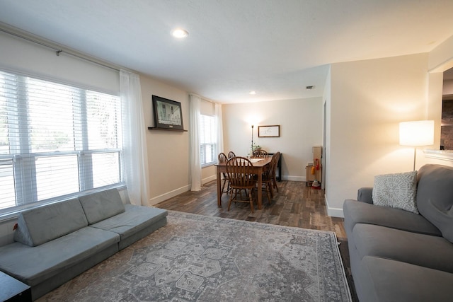 living area featuring recessed lighting, baseboards, and wood finished floors