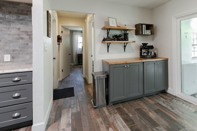 bar featuring dark wood-type flooring and baseboards