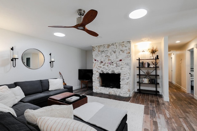 living room with a ceiling fan, baseboards, dark wood finished floors, recessed lighting, and a fireplace