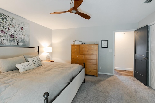 bedroom featuring baseboards, carpet floors, visible vents, and ceiling fan