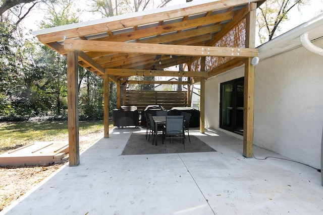 view of patio with outdoor dining area and fence