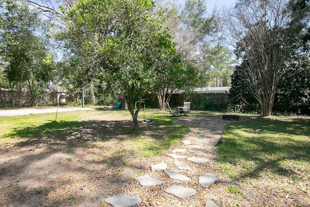 view of yard with a playground and fence