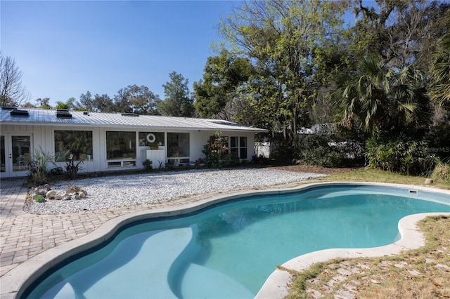 pool with a patio area and french doors